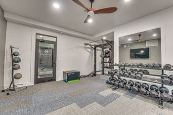 Fitness center with dumbbell racks and workout equipment